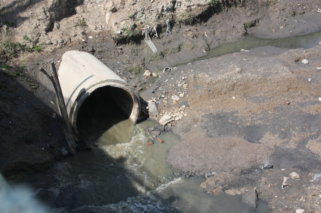 Waste being pushed into the river