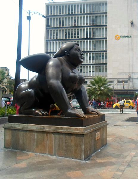 Kids mucking around on one of Botero's statues. And, woah! check it! A dude abseilling on the building in the background!